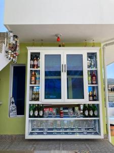 a cabinet filled with lots of bottles of beer at Tropical Inn Spacious 1 bed Apartment stunning rooftop terrace in San Felipe de Puerto Plata