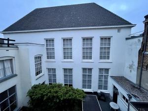 a white house with a black roof at Kerkstraatje3 in Zutphen