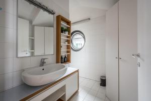 米兰tHE Orange Attic - Navigli Area的一间白色浴室，配有洗手池和镜子。 更多48张照片