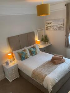 a bedroom with a large bed with two lamps at Rivendell Guest House in Swanage