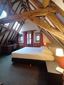 a bedroom with a large bed in an attic at Hotel Koffieboontje in Bruges