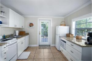 a kitchen with white cabinets and a white refrigerator at Pirates Pointe Resort in Ruskin