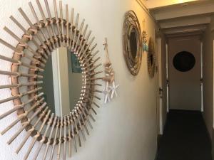 a mirror hanging on a wall in a hallway at De Witte Handt in Midsland