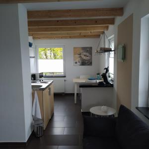 a kitchen with a couch and a table at Apartment "Stine" in Erpen