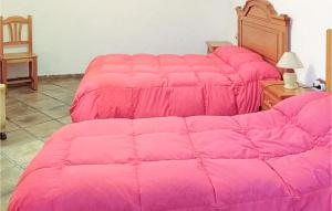 a bed with pink sheets on top of it at Cozy Home In Baza With Wifi in Baza