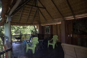 a porch with chairs and a table on a deck at Guest House Bavaria in Rundu