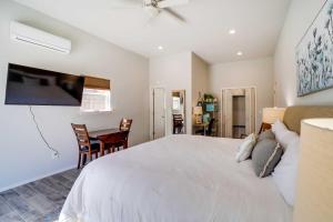 a bedroom with a large white bed and a table at Tulsa Vacation Home about 3 Mi to Downtown in Tulsa