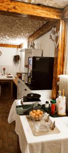 a kitchen with a counter with a bowl of oranges on it at Pension TTT in Bled