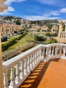 a white balcony with a view of a city at Los Alamos Somhome in Peniscola