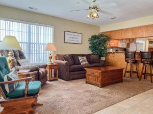 a living room with a couch and a table at Lake Front 2BR Walk-In with Large Deck - FREE TICKETS INCLUDED - 79-1 in Branson