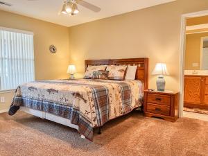 a bedroom with a bed and a night stand with two lamps at Lake Front 2BR Walk-In with Large Deck - FREE TICKETS INCLUDED - 79-1 in Branson