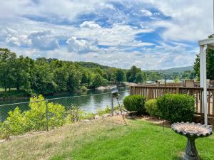 a view of a river from the backyard of a house at Lake Front 2BR Walk-In with Large Deck - FREE TICKETS INCLUDED - 79-1 in Branson