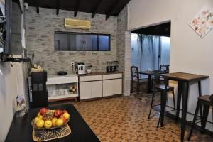 a kitchen with a table with a bowl of fruit on it at Las Orquídeas Hotel Boutique in Asuncion