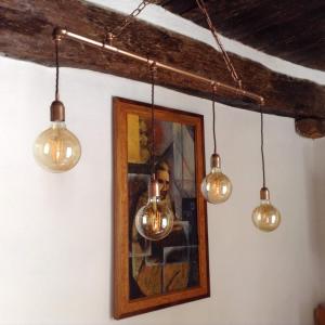 a group of lights hanging from a wall with a picture at Casa SILVIO in Sesta Godano