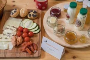 a wooden table with two plates of food on it at Chalet Apartments ALPIK in Bohinj