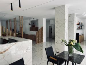 a kitchen and dining room with a table and chairs at International Hotel in Rhodes Town