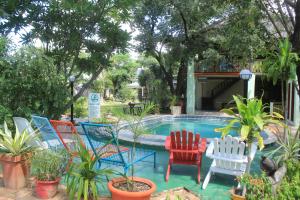 a group of chairs sitting around a swimming pool at Guest House Bavaria in Rundu