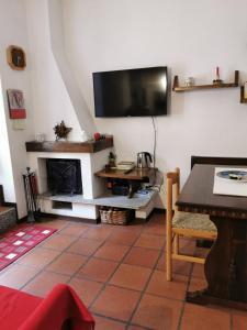 a living room with a flat screen tv on the wall at Appartamento Alba - Residence Montesole in Ponte di Legno