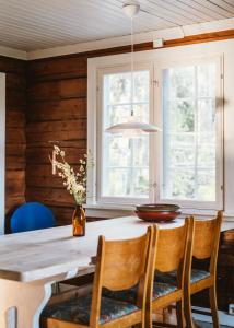 a dining room with a wooden table and chairs at Breiva Gjestegaard og Glamping in Bø
