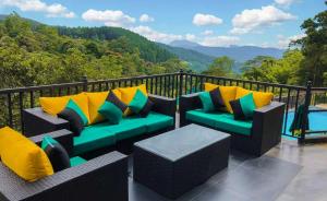 a balcony with couches and a view of the mountains at The Grand Hills in Kandy