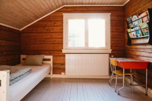 a small room with a bed and a window at Breiva Gjestegaard og Glamping in Bø