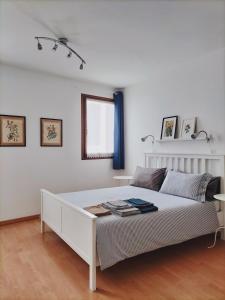 a white bedroom with a white bed and a window at Riviera Garibaldi in Treviso