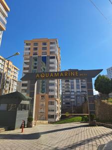 a sign for an apartment building in a city at AKUA 23 in Trabzon