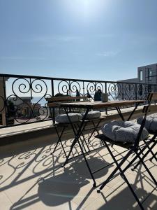 a table and chairs on top of a balcony at Cosy apartments with sea view in complex PANORAMA in Chernomorets