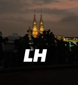 a lit up sign in front of a city at night at Lujan Homes in Luján