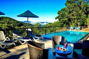 a patio with chairs and a swimming pool at The Grand Hills in Kandy