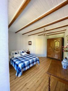 a bedroom with a bed and a wooden floor at Chez Sarah - L'Escapade in Javerlhac-et-la-Chapelle-Saint-Robert