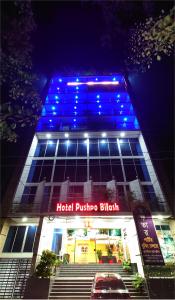 a building with blue lights on top of it at Hotel Pushpo Bilash in Khulna