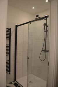 a shower in a bathroom with a glass door at RE Versiliana Junior-House in Marina di Pietrasanta