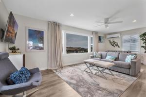 a living room with a couch and two chairs at Tower 9 #2 in Oceanside