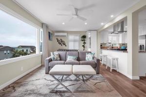 a living room with a couch and a kitchen at Tower 9 #2 in Oceanside