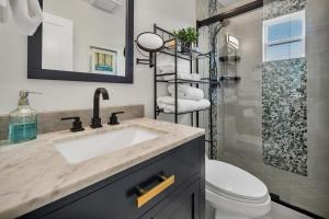 a bathroom with a sink and a toilet and a shower at Tower 9 #2 in Oceanside +53 photos