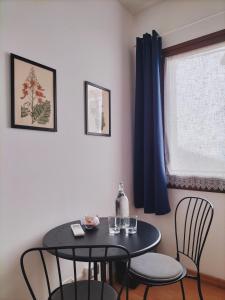 a black table and chairs in a room with a window at Riviera Garibaldi in Treviso