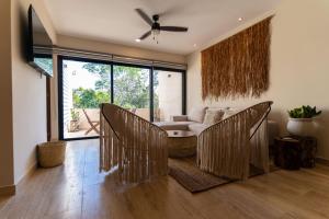 a living room with a couch and a table and chairs at Luxury & Modern Apartments in Tulum Top Amenities By Yeah in Tulum