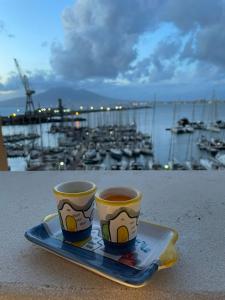 two cups of coffee sitting on a tray on a table at coraline in Castellammare di Stabia
