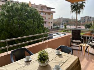 a table and chairs on top of a balcony at Apartamentos LOS TULIPANES in Salou