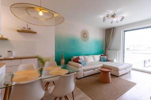 a living room with a couch and a table and chairs at Apartment at the Lake and view in Fonyód