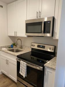 a kitchen with a stove and a microwave at Innovative Studio Apartment in Gadsden