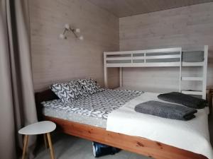 a bedroom with a bunk bed and a chair at FOREST LAKE in Kščava
