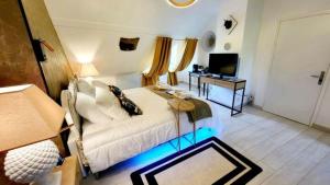 a bedroom with a white bed and a television at VILLA RAFFAELLA in Les Albres
