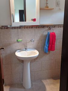 a bathroom with a white sink and a mirror at Colibri Apart Eldorado in Eldorado