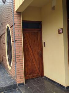 a wooden door on the side of a building at Colibri Apart Eldorado in Eldorado