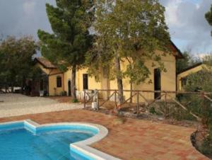 a house with a swimming pool in front of a house at Villa Segreta, Mount Etna in Belpasso