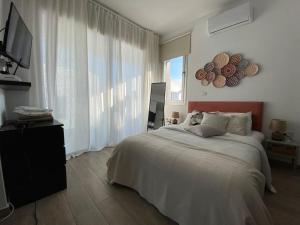 a bedroom with a bed and a large window at Protaras LUX Villa, Swimming pool, BBQ grill, Near beach in Protaras
