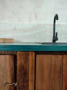 a kitchen counter with a sink with aaucet at Elite apartment in Limenaria