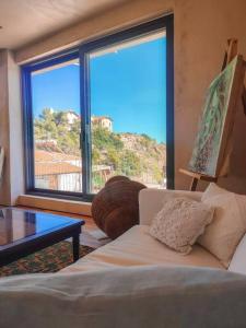 a living room with a couch and a large window at Elite apartment in Limenaria